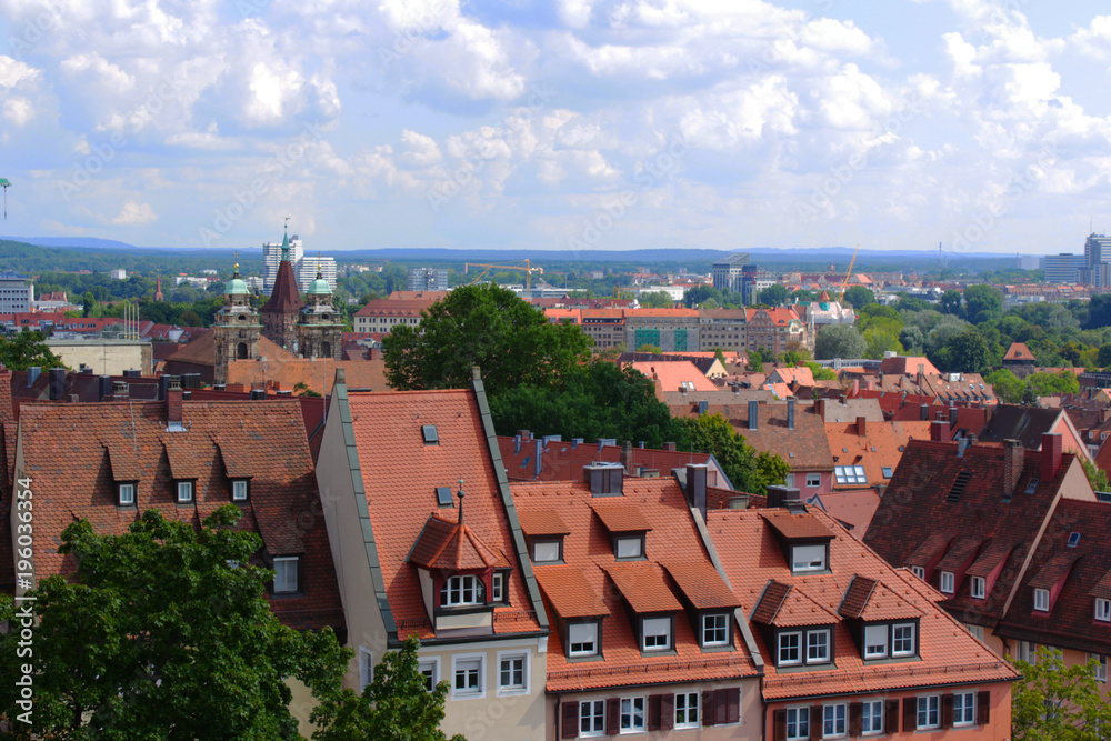 Obraz premium Multicolored houses with multi-colored roofs. View of the city.