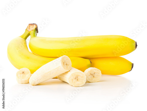 Bundle of fresh, ripe, yellow bananas with sliced banana pieces