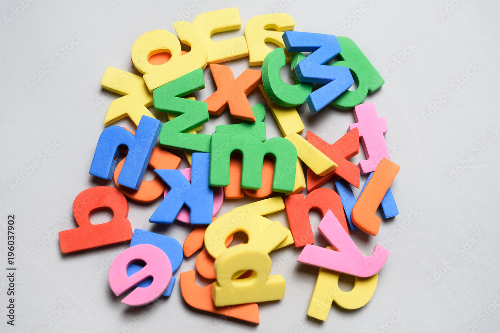 Naklejka premium Colorful letters toys on a white background.