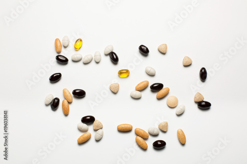 Pills, vitamins, fish oil on white background