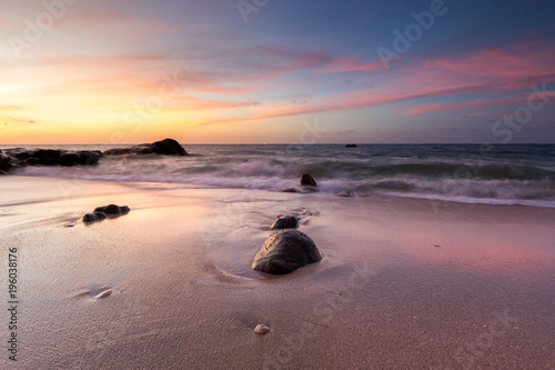 view of seascape during sunset with waves trails.