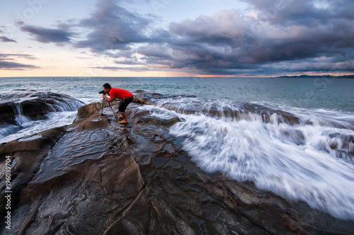 view of seascape during sunset with waves trails.