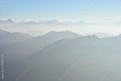 Hazy silhouette of mountains in the European Alps. Allgaeu Alps and Lechquellengebirge, Germany, Austria.