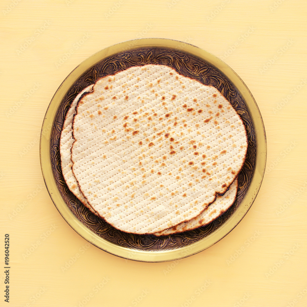 passover background with matzoh over yellow wooden background. passover background with matzoh over yellow wooden background.