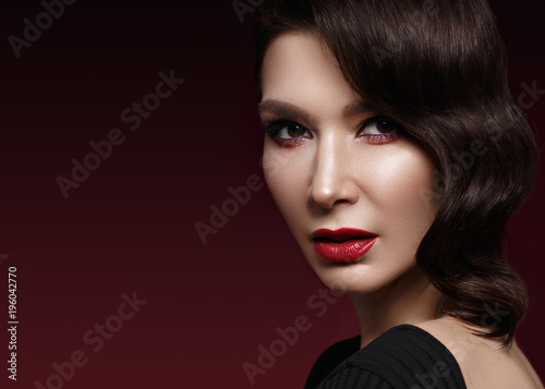 beautiful girl in Hollywood image with wave hair and classic makeup. Beauty face. Photo taken in the studio.