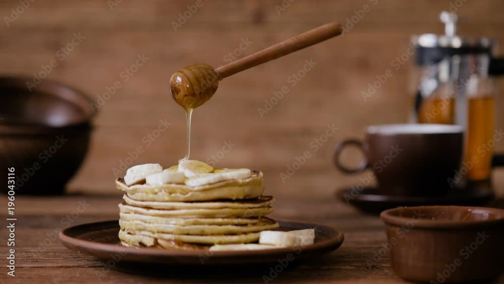 Cinemagraph - Breakfast, pouring honey on pancakes. Nobody. Living Photo.