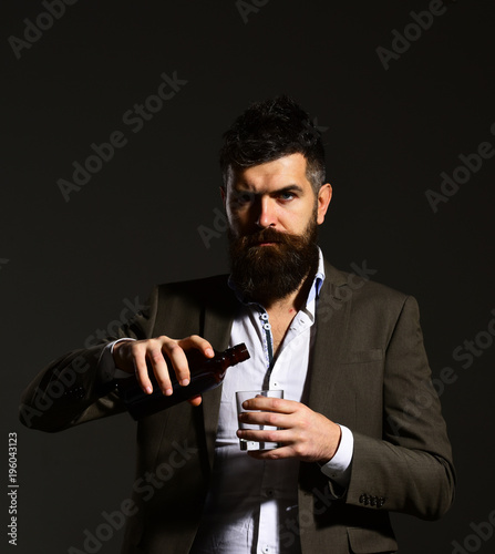 Businessman with serious face in suit on black background