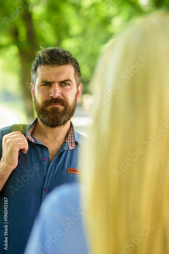 First meet of strangers, man with beard looks at blonde.