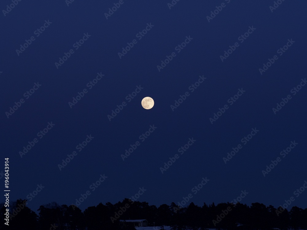 A shining and golden full moon over the pastel colour sky, Espoo, Finland