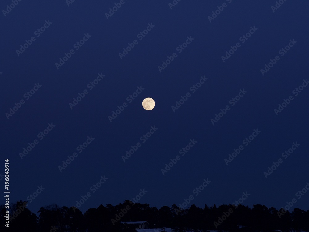 A shining and golden full moon over the pastel colour sky, Espoo, Finland A shining and golden full moon over the pastel colour sky, Espoo, Finland