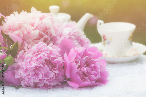 Peony bouquet and a teacup with a faded effect.