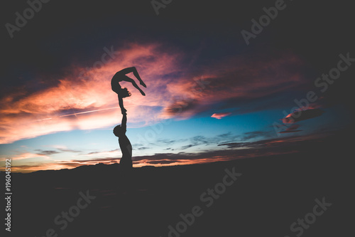 acrobatics silhouette in the sunset yoga photo