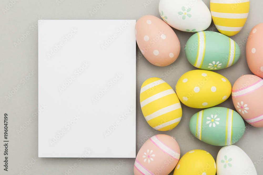 Easter holiday background. Pastel coloured decorated easter eggs with a blank white label.