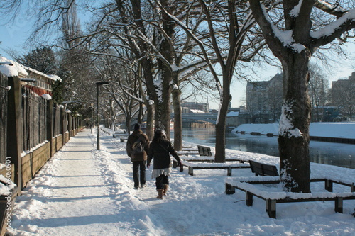 Snowy riverfront walk and bridges in York, England