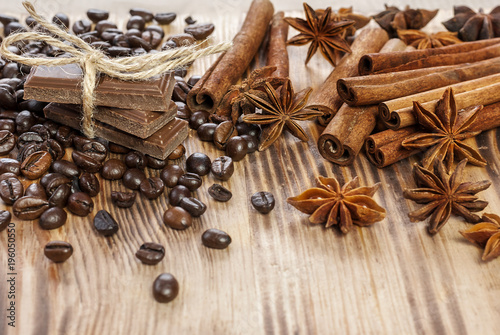 Chocolate, Coffee Beans, Spices, Cinnamon on the Wooden Table.