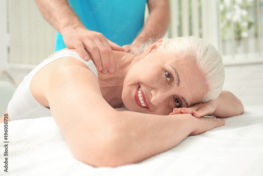 Elderly woman getting massage at physical therapy office Elderly woman getting massage at physical therapy office
