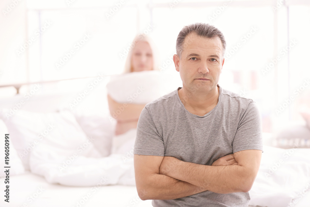 Senior couple with problem in relationship on bed at home Senior couple with problem in relationship on bed at home