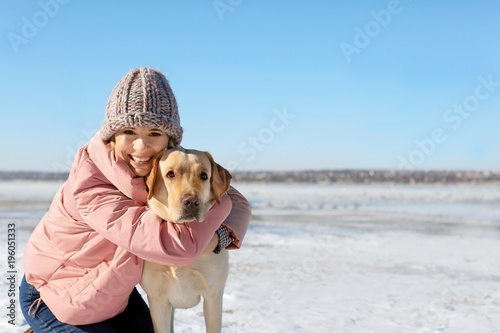 Portrait of woman hugging c...