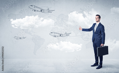 Businessman hitchhiking with airplanes around photo