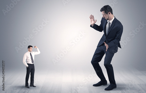 Giant businessman scared of small businessman