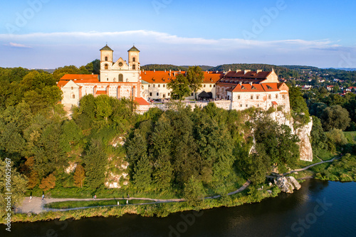 Benedictine abbey on the rocky hill in Tyniec near Cracow, Poland, and Vistula River. Aerial view at sunset