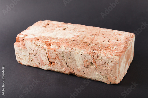 Red brick on black background