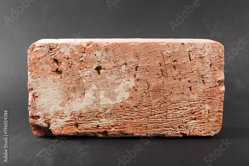 Red brick on black background