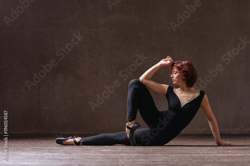 Young beautiful ballerina posing in studio