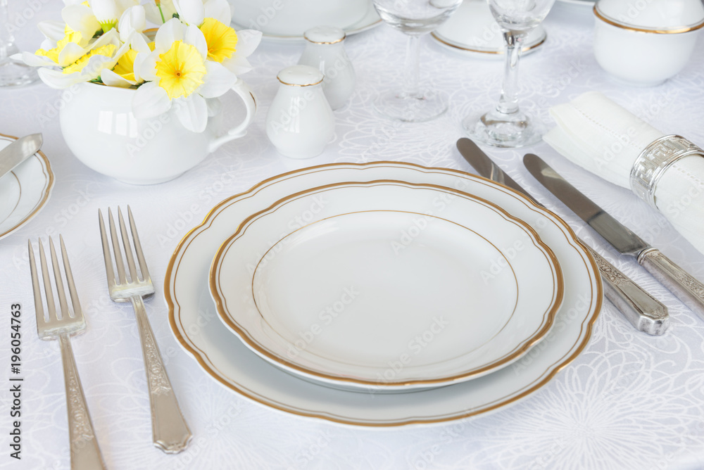 Luxurious porcelain, silverware and spring flowers Luxurious porcelain, silverware and spring flowers