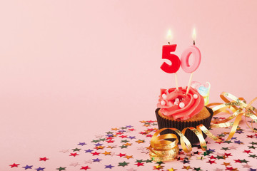 50th birthday cupcake with candle and sprinkles