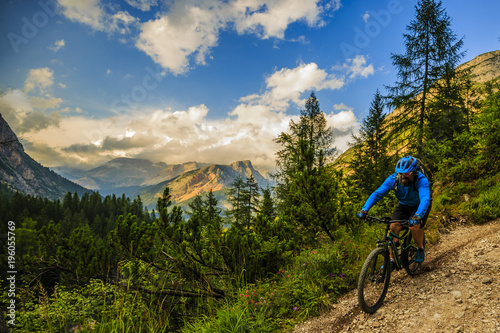 Tourist cycling in Cortina d'Ampezzo, stunning rocky mountains on the background. Man riding MTB enduro flow trail. South Tyrol province of Italy, Dolomites. © Gorilla