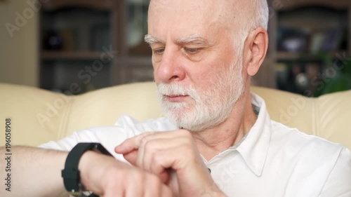 Wallpaper Mural Senior man using smartwatch, browsing, reading news. Modern pensioner chatting with friends on smart watch. Concept of technology use by older people. Active modern life after retirement Torontodigital.ca