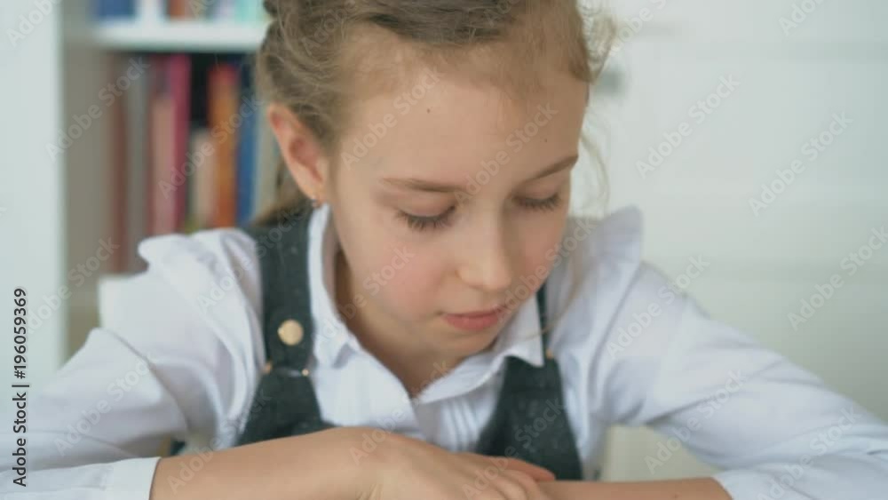 Cute little girl is reading book. Slow motion. Cute little girl is reading book. Slow motion.