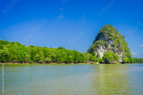 Beautiful outdoor view of huge mountains in the horizont, viewed from the river during a gorgeopus blue asky in Krabi Province, South of Thailand photo