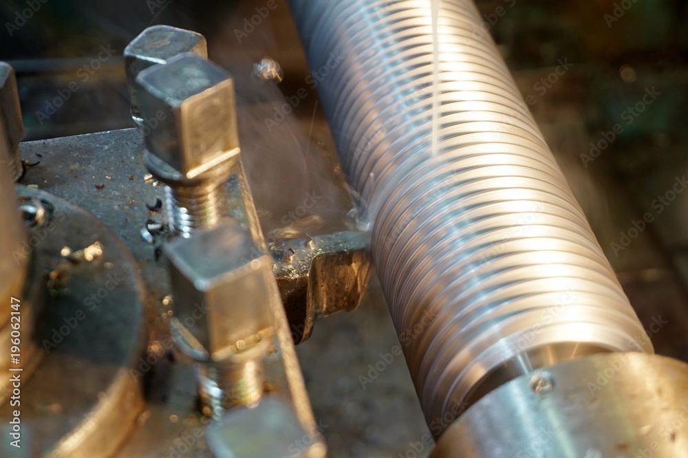 threading the shaft on the machine, a mechanical cutter threading the shaft on the machine, a mechanical cutter