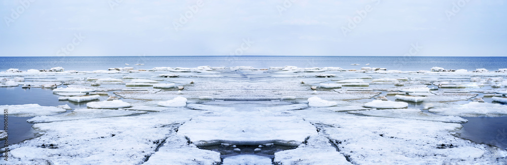 Ice drift on Baltic sea. Spring cloudy day.