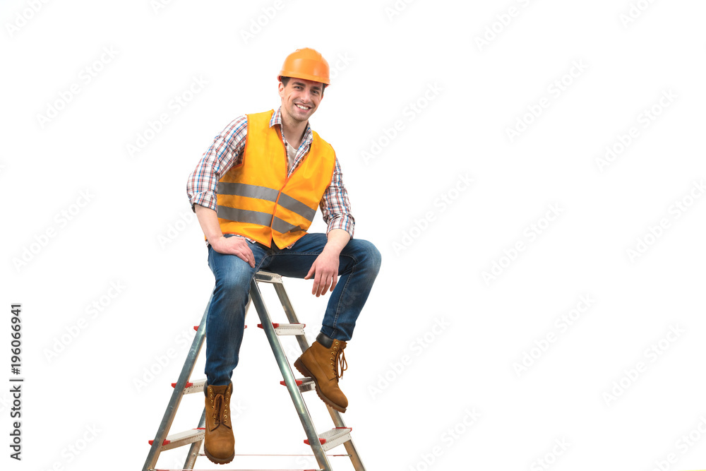 The happy builder sitting on the ladder on the white background