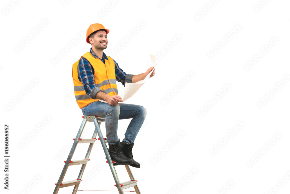 The happy builder with a paper sitting on the ladder on the white background The happy builder with a paper sitting on the ladder on the white background
