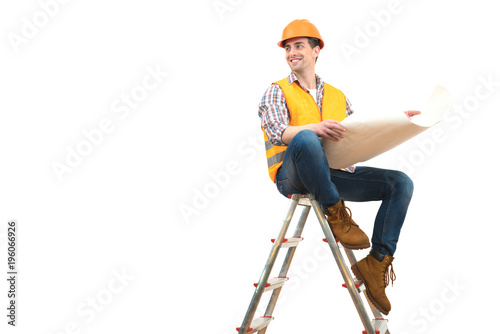 The happy engineer with a paper sitting on the ladder on the white background