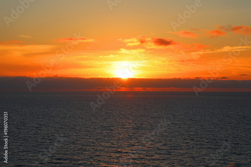 Sea and sunset with sun rays.