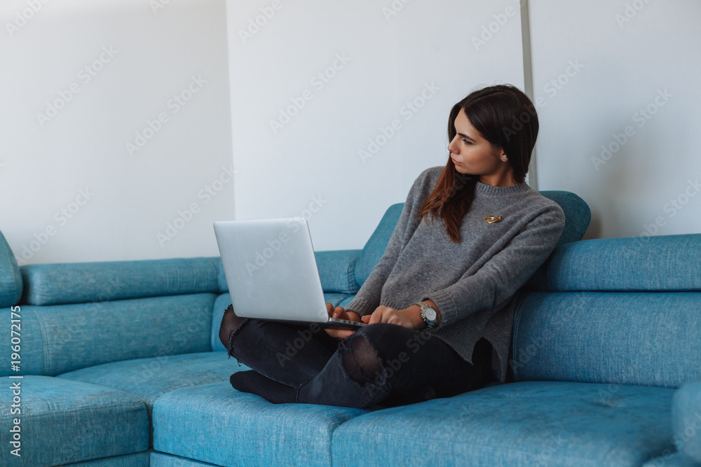 girl with laptop on the sofa and white wall girl with laptop on the sofa and white wall