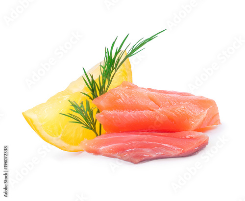 Slice of salmon with a slice of lemon close-up on a white background
