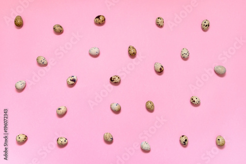 Quail eggs on pink background, copy space. Healthy food concept. Top view, flat lay. Easter eggs. Happy Easter concept