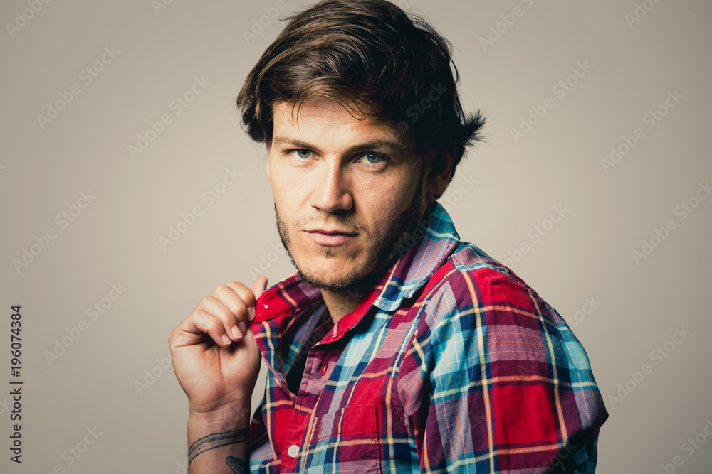caucasian man wearing checkered shirt and trendy hairstyle caucasian man wearing checkered shirt and trendy hairstyle