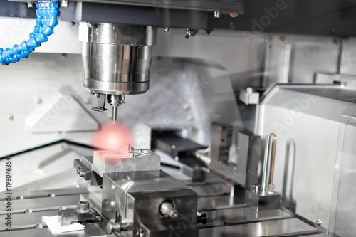 High precision CNC machining center working, operator machining automotive sample part process