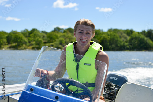 Happy boy driving boat