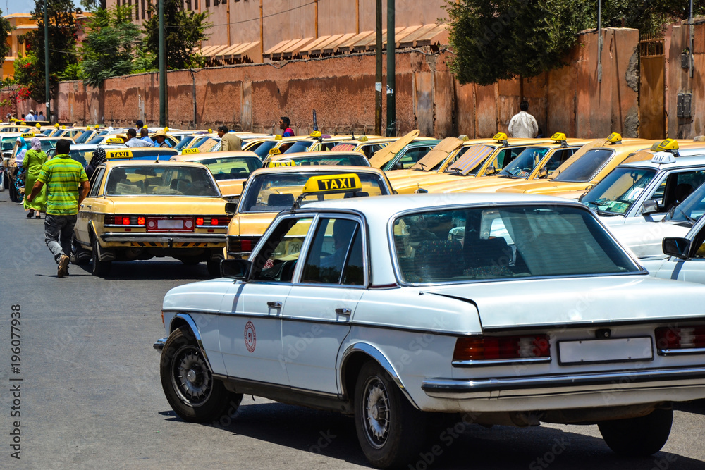 Cabs waiting for clients at a taxi station of Marrakech (Morocco)