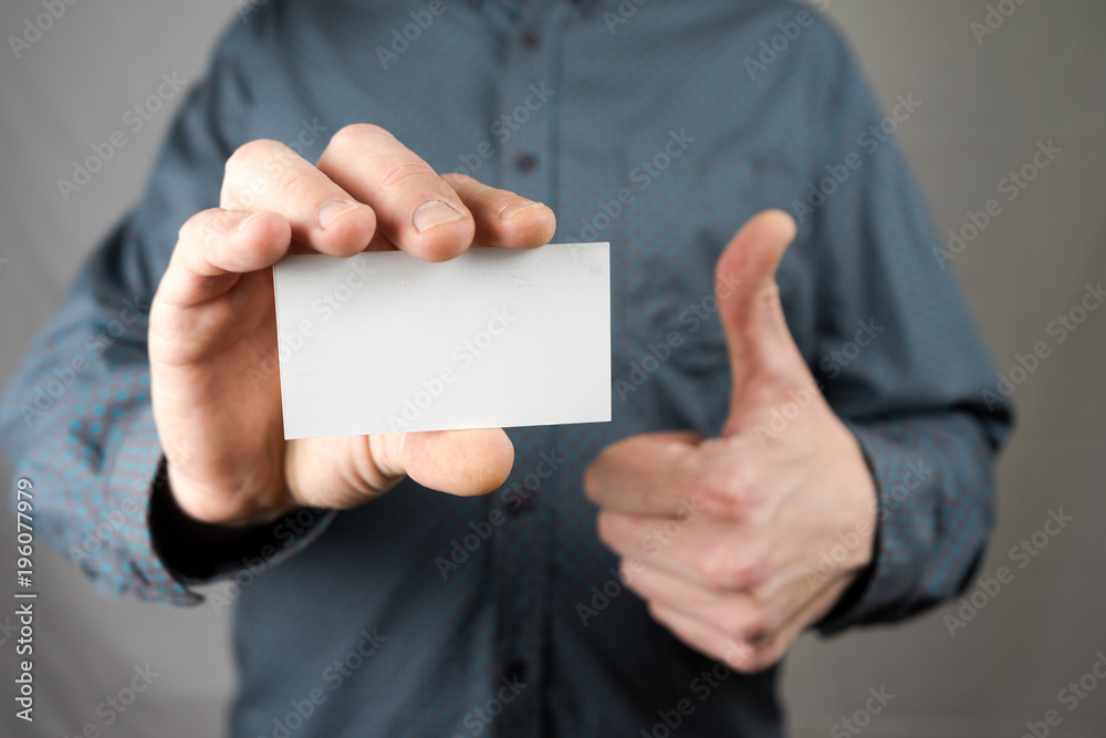 Businessman holding a business card. Mock up. Copy space. Businessman holding a business card. Mock up. Copy space.