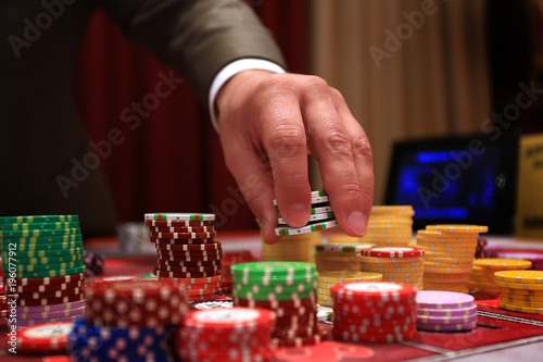 Player placing chips on a gambling table in casino