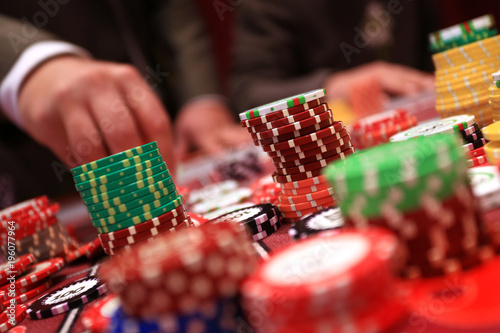 Player placing chips on a gambling table in casino